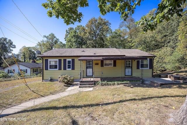 ranch-style home with a front yard and a porch