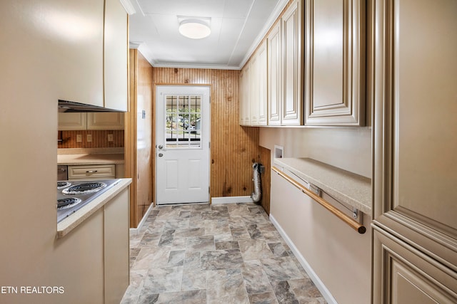 kitchen featuring crown molding, stainless steel cooktop, and cream cabinetry