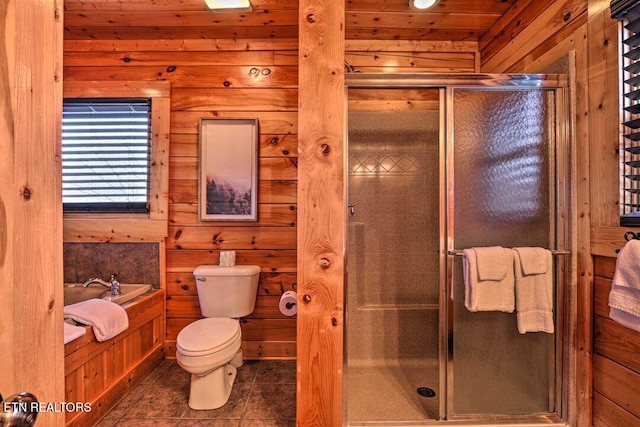 bathroom featuring separate shower and tub, wood walls, toilet, and tile patterned floors