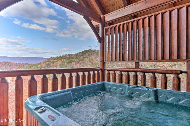 wooden deck with a hot tub