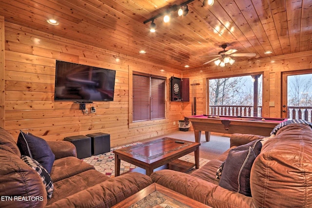 carpeted living room with ceiling fan, wood ceiling, wood walls, rail lighting, and billiards