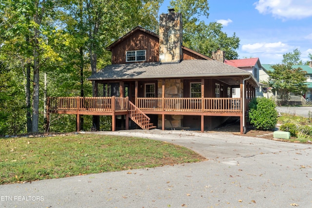 view of front of house with a front yard and a deck