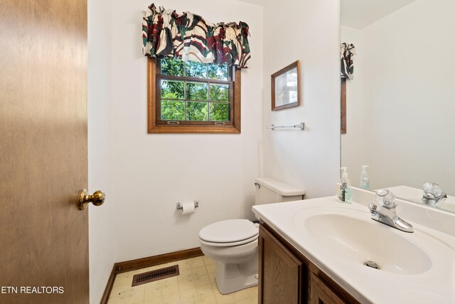 bathroom with vanity and toilet