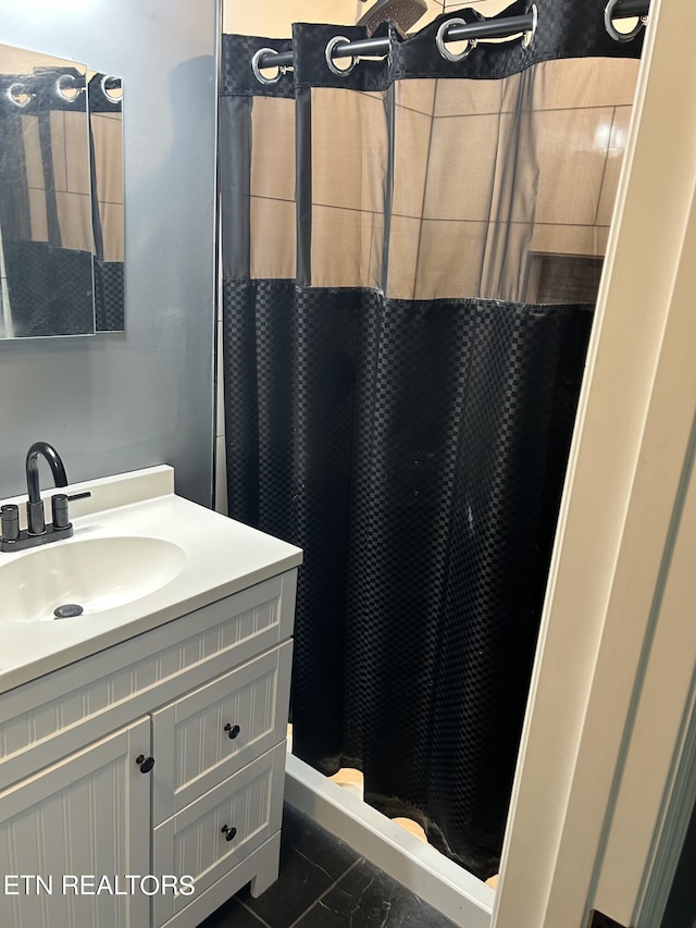 bathroom featuring vanity, tile patterned floors, and curtained shower