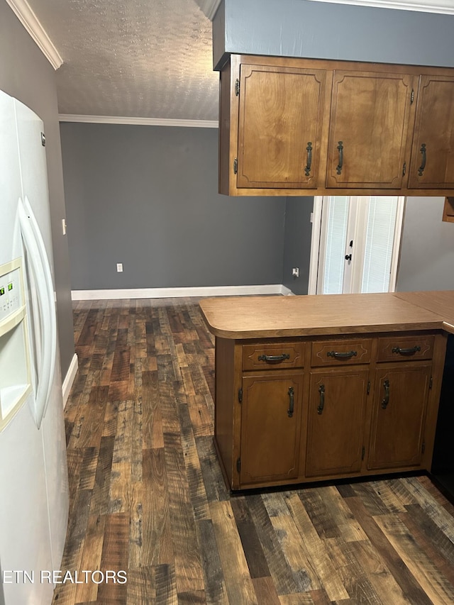 kitchen featuring white fridge with ice dispenser, crown molding, dark wood-type flooring, and kitchen peninsula