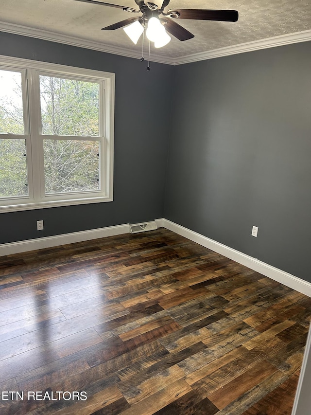 spare room featuring ceiling fan, ornamental molding, and dark wood-type flooring