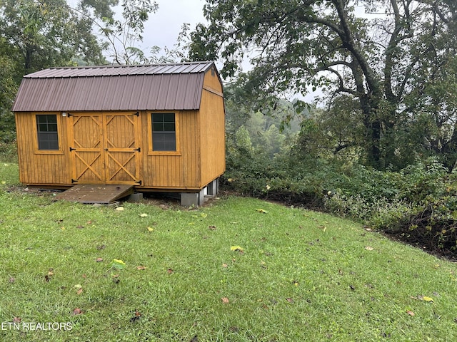 view of outbuilding with a lawn