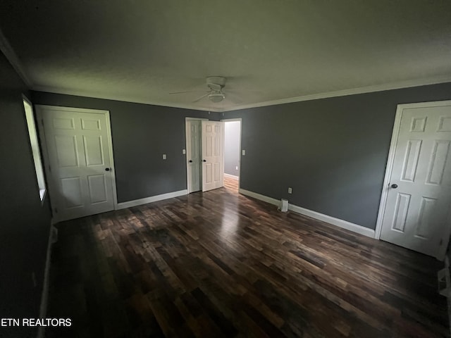 unfurnished bedroom with ceiling fan, crown molding, and dark hardwood / wood-style flooring