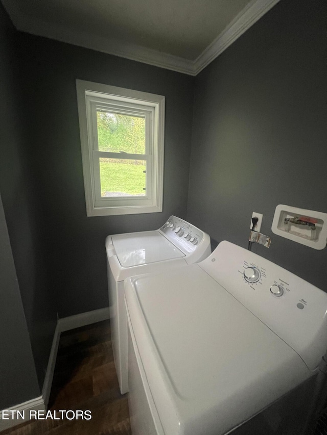 clothes washing area with dark hardwood / wood-style floors, separate washer and dryer, and crown molding