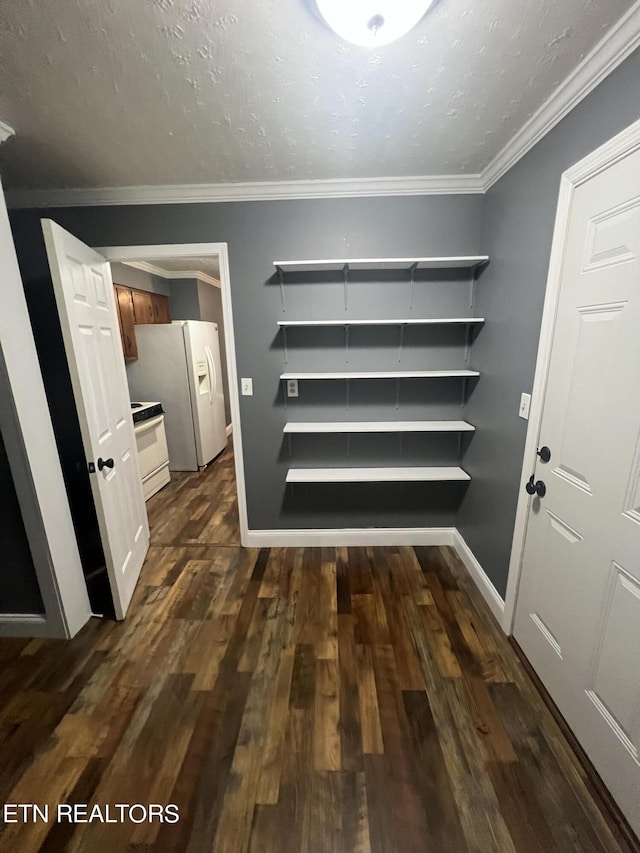 corridor with a textured ceiling, crown molding, and dark hardwood / wood-style floors