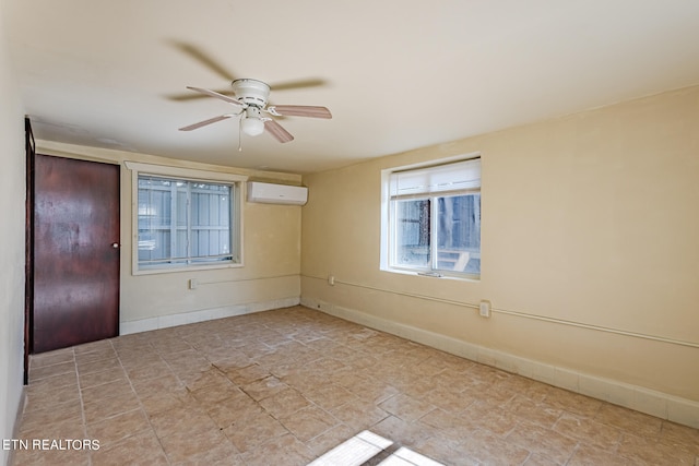 empty room featuring an AC wall unit and ceiling fan