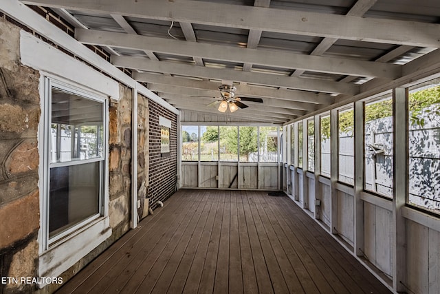 unfurnished sunroom with ceiling fan