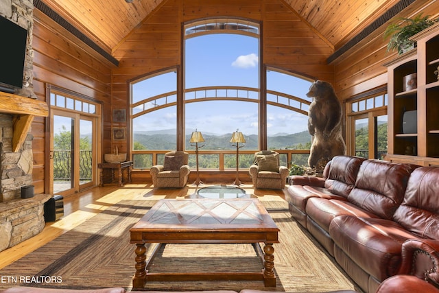 living room featuring a mountain view, wood ceiling, and a wealth of natural light