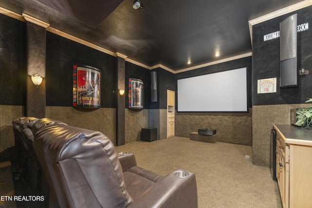 carpeted home theater featuring crown molding