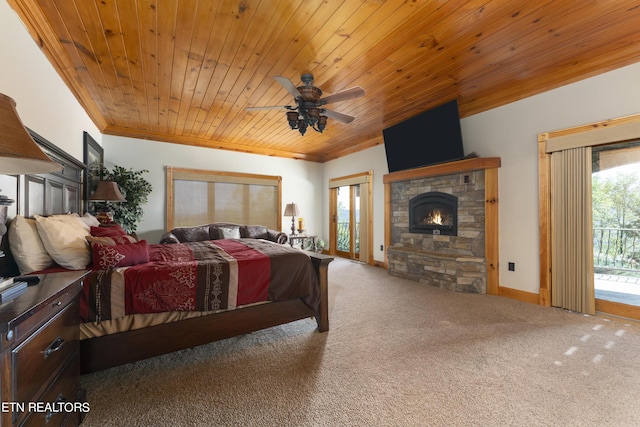 carpeted bedroom with access to exterior, a stone fireplace, ceiling fan, and wood ceiling