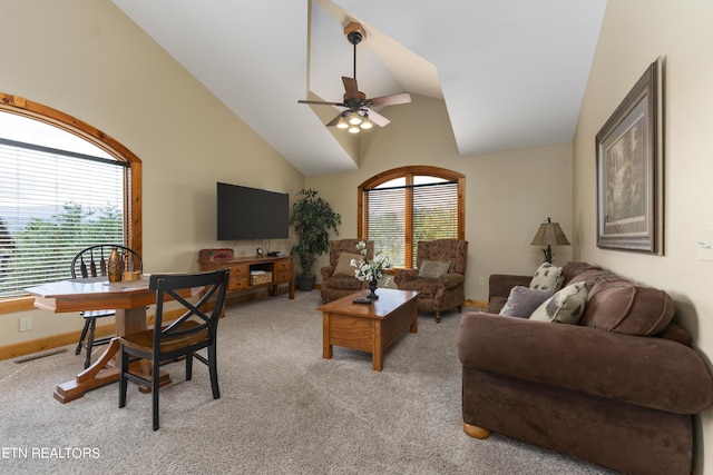 carpeted living room with ceiling fan and vaulted ceiling