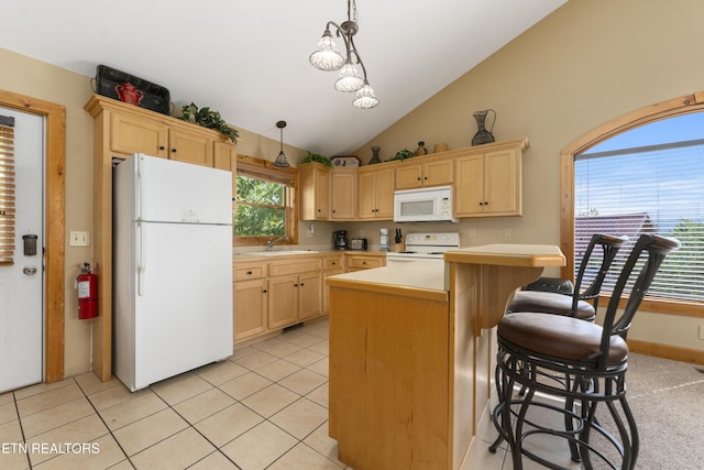 kitchen with pendant lighting, light brown cabinets, white appliances, sink, and vaulted ceiling