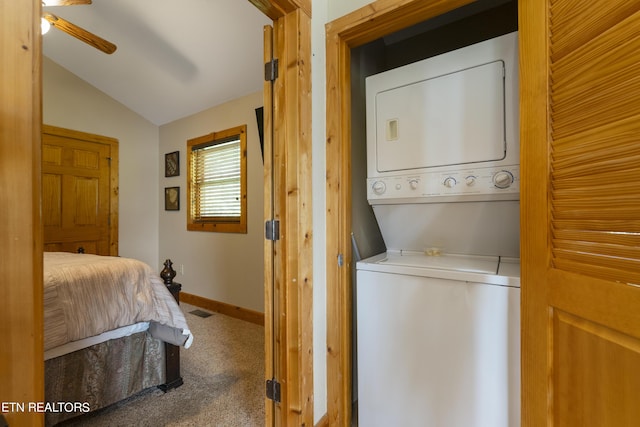 laundry room featuring carpet, stacked washer / dryer, and ceiling fan