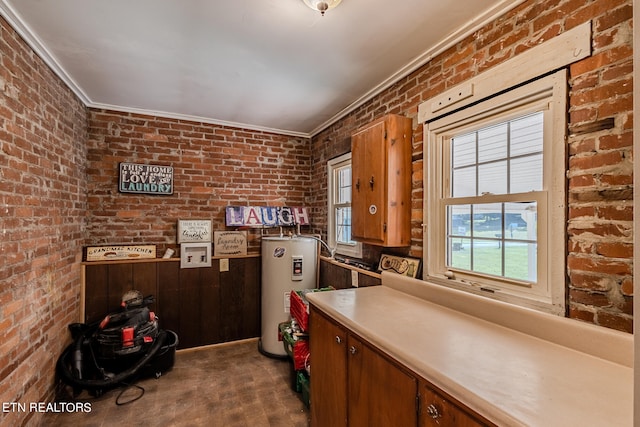 kitchen with crown molding, dark carpet, electric water heater, and brick wall