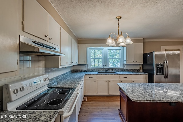 kitchen with stainless steel fridge, white cabinetry, and white range with electric stovetop