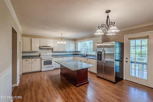 kitchen featuring white range with electric cooktop, stainless steel refrigerator with ice dispenser, decorative light fixtures, and hardwood / wood-style flooring