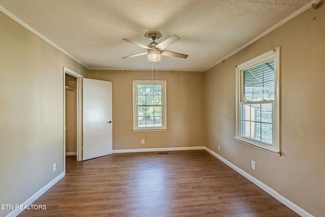 interior space with a textured ceiling, ornamental molding, ceiling fan, and hardwood / wood-style flooring