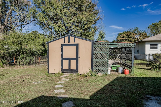 view of outbuilding with a lawn