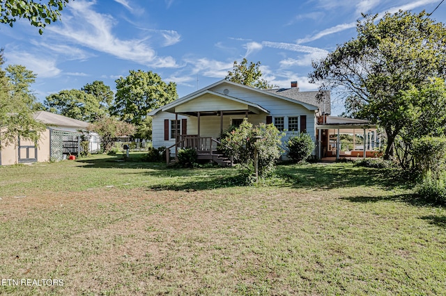 rear view of property with a lawn