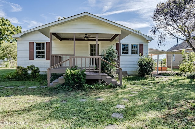 bungalow with ceiling fan, a porch, and a front lawn