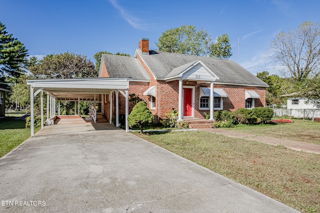 view of front of property with a front yard and a carport