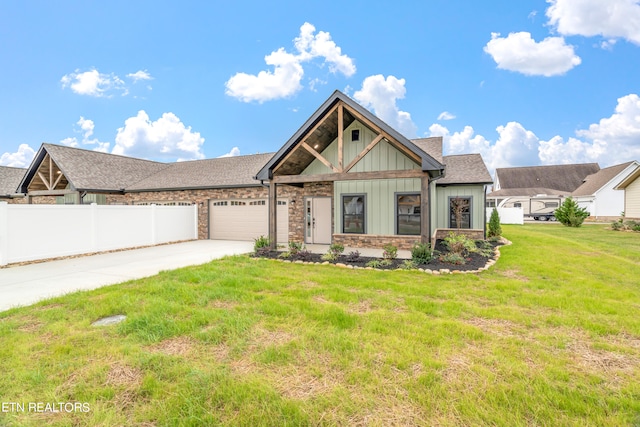 craftsman inspired home featuring a garage and a front lawn