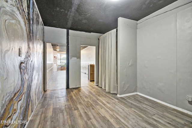 unfurnished room with hardwood / wood-style floors