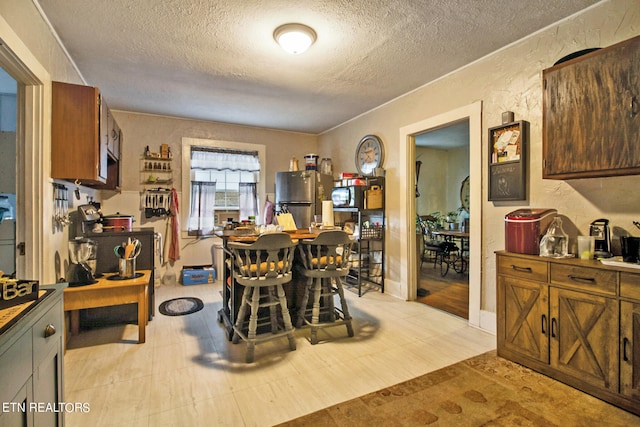 dining space with a textured ceiling