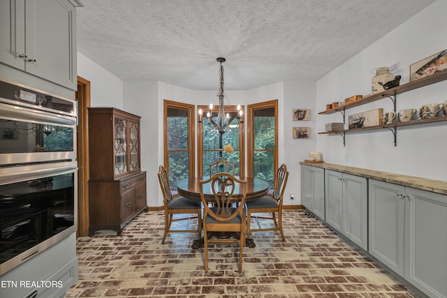 dining room with a notable chandelier and a textured ceiling