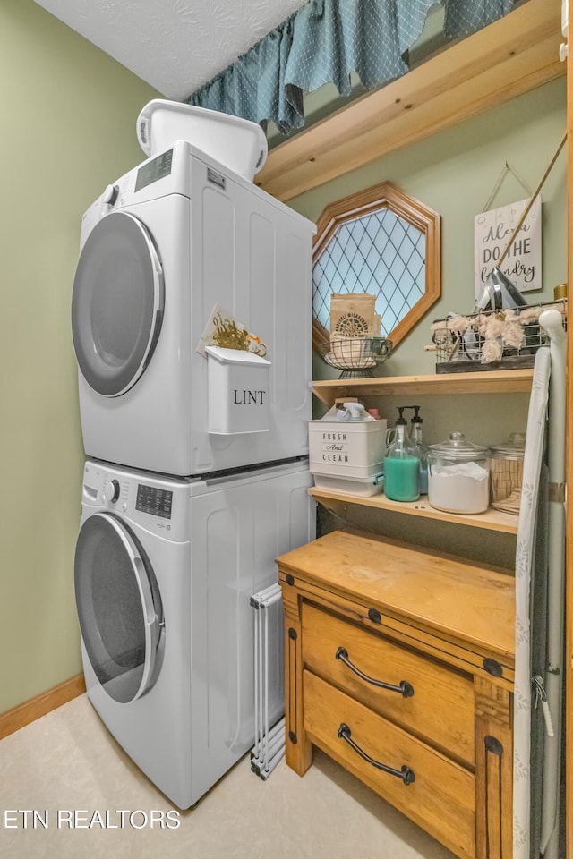 clothes washing area with stacked washer and dryer