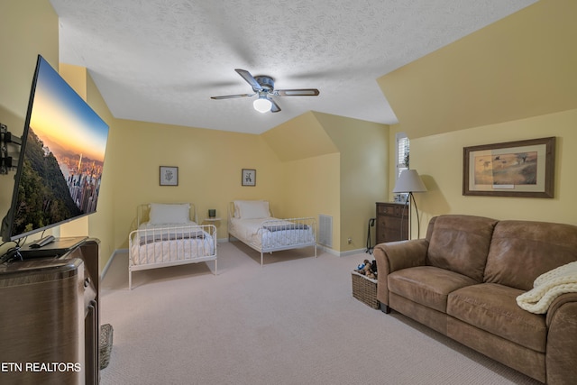 bedroom featuring lofted ceiling, ceiling fan, a textured ceiling, and carpet flooring