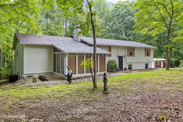 rear view of house featuring a sunroom