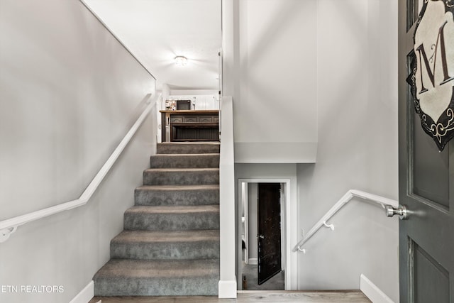 stairs with hardwood / wood-style flooring