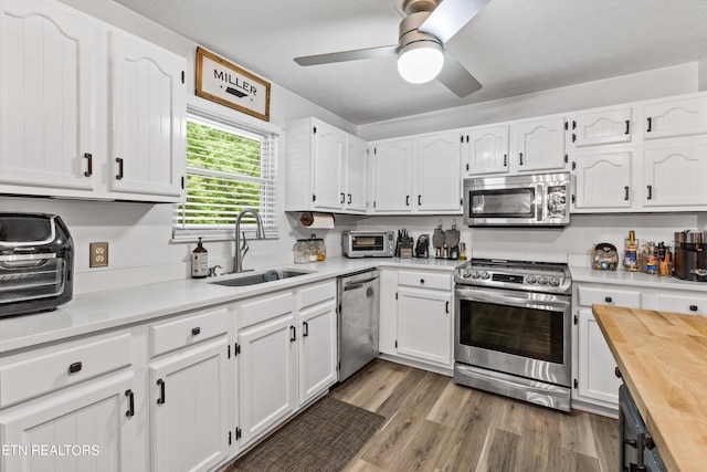 kitchen featuring stainless steel appliances and white cabinetry