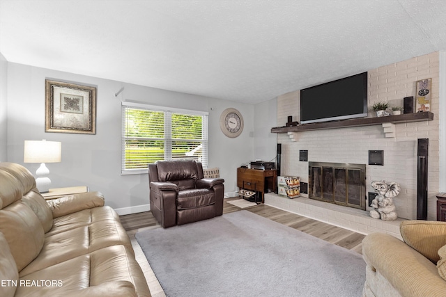 living room with hardwood / wood-style flooring and a brick fireplace