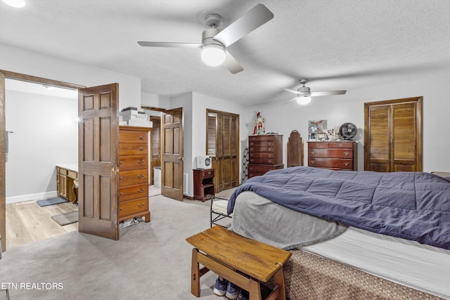 carpeted bedroom with ceiling fan and a textured ceiling