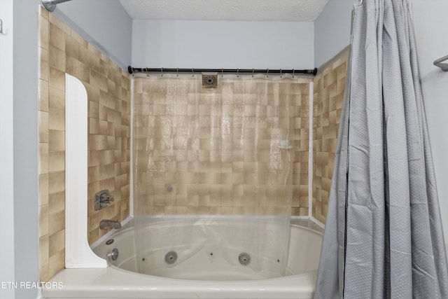 bathroom featuring shower / bathtub combination with curtain and a textured ceiling