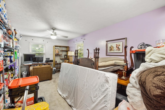 interior space with ceiling fan, light colored carpet, a textured ceiling, and plenty of natural light