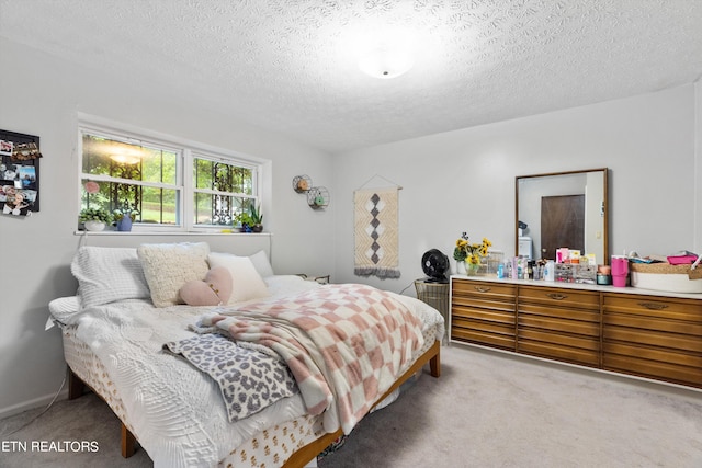 carpeted bedroom featuring a textured ceiling