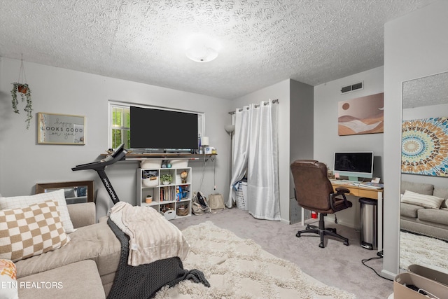 carpeted home office with a textured ceiling