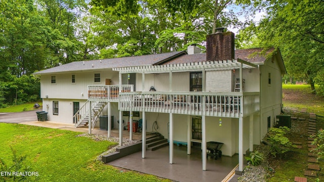 rear view of property with a deck, central AC unit, and a patio area