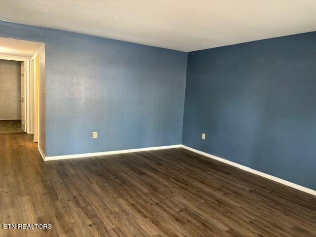 empty room featuring dark hardwood / wood-style flooring