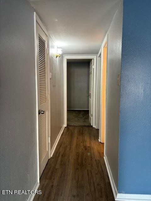 corridor featuring dark hardwood / wood-style floors