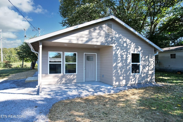 bungalow featuring a patio area