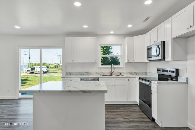 kitchen featuring dark wood-type flooring, stainless steel appliances, sink, and white cabinets